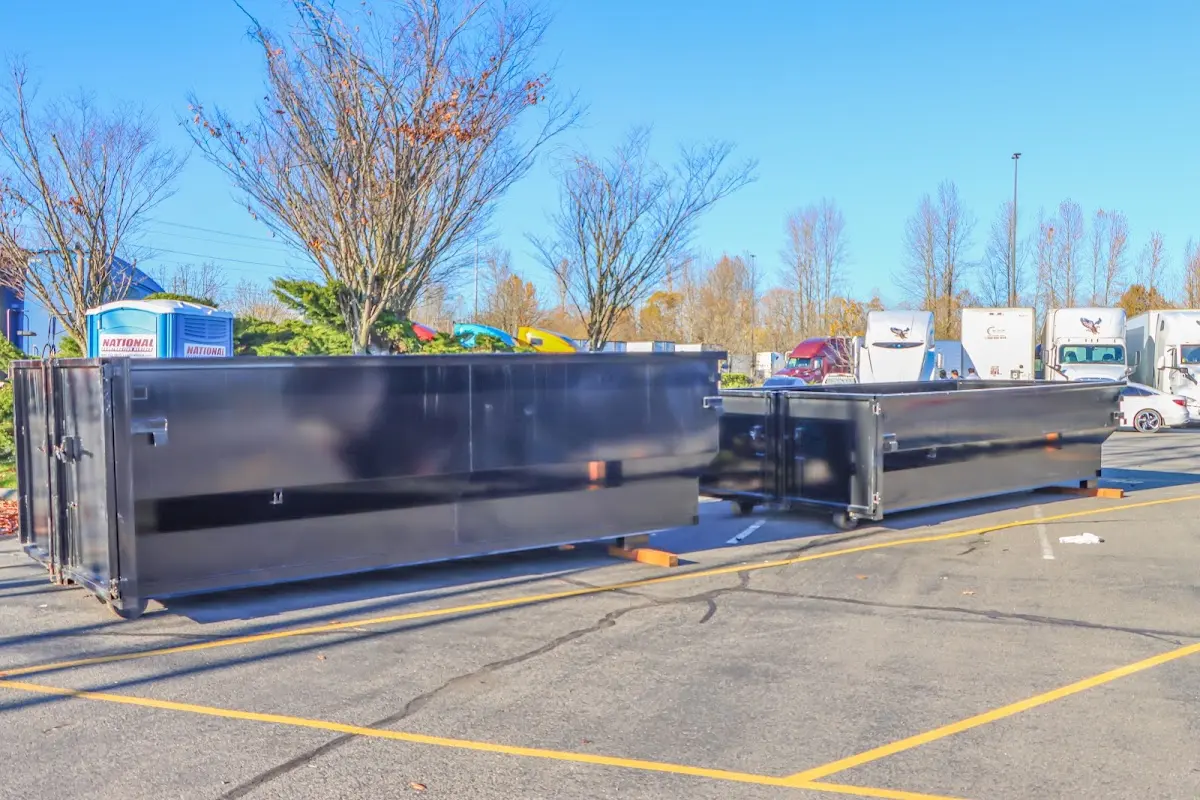 Professional dumpster rental service with roll-off container on residential driveway in Crystal Lake